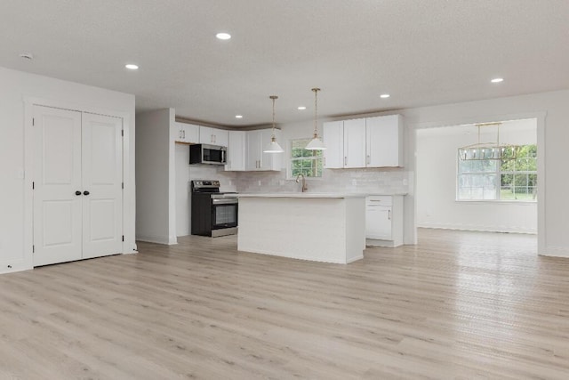 8208 Hixson Springs Rd, Signal Mountain, TN 37377 - kitchen with appliances with stainless steel finishes, plenty of natural light, white cabinets, light wood finished floors, and recessed lighting