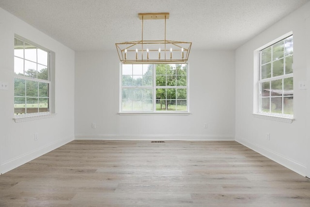 8208 Hixson Springs Rd, Signal Mountain, TN 37377 - spare room with a textured ceiling, a chandelier, and wood finished floors