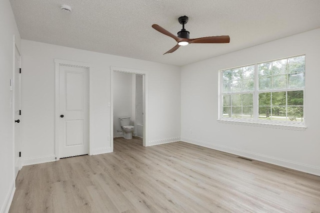 8208 Hixson Springs Rd, Signal Mountain, TN 37377 - unfurnished bedroom with light wood finished floors, a textured ceiling, ensuite bathroom, and a ceiling fan