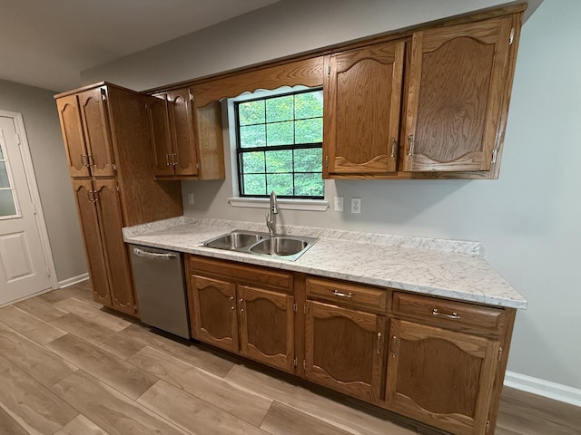 9424 Fuller Rd, Chattanooga, TN 37421 - kitchen featuring dishwasher, light countertops, light wood-style flooring, and brown cabinets