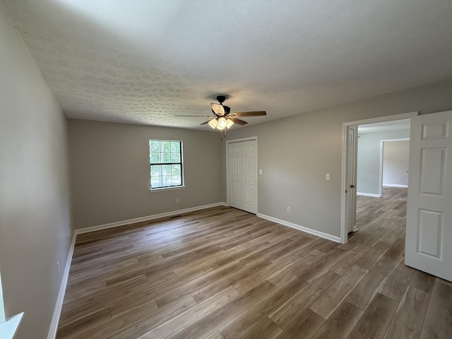 9424 Fuller Rd, Chattanooga, TN 37421 - unfurnished bedroom featuring wood finished floors, a closet, ceiling fan, and a textured ceiling