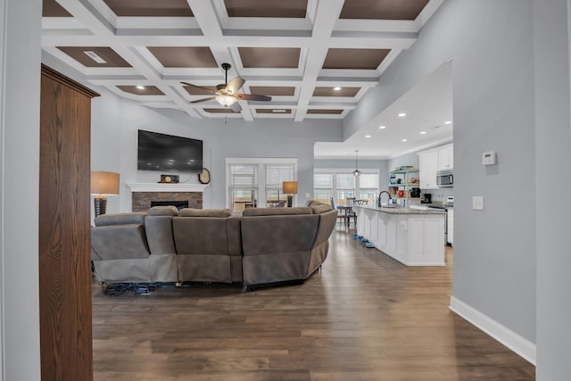 386 Twelve Oaks Dr, Rock Spring, GA 30739 - living room with ceiling fan, dark wood-style floors, beam ceiling, a fireplace, and coffered ceiling
