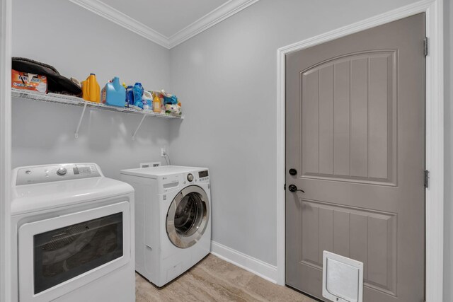 386 Twelve Oaks Dr, Rock Spring, GA 30739 - washroom with washing machine and clothes dryer, ornamental molding, and light wood-style floors