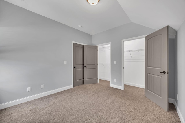 386 Twelve Oaks Dr, Rock Spring, GA 30739 - unfurnished bedroom featuring carpet, lofted ceiling, and two closets