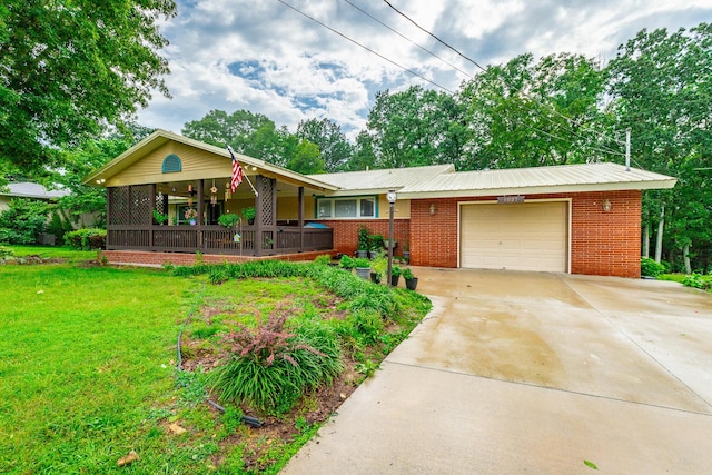 1027 Crestridge Dr, Rossville, GA 30741 - view of front of property featuring a garage, concrete driveway, a front yard, brick siding, and a metal roof