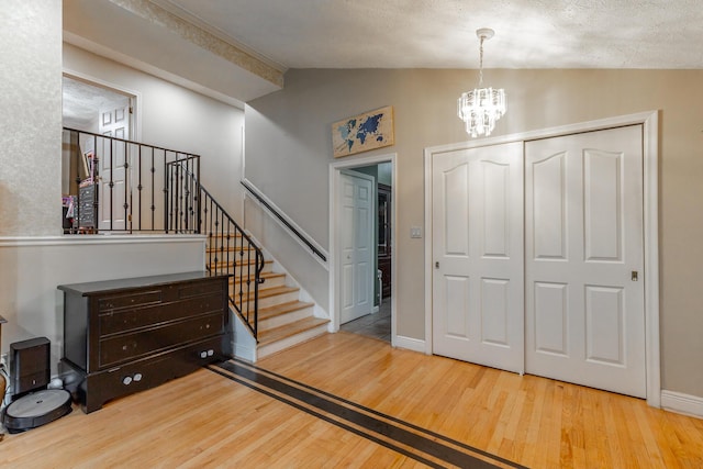1027 Crestridge Dr, Rossville, GA 30741 - entryway with vaulted ceiling, wood finished floors, a chandelier, and stairs