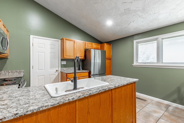 1027 Crestridge Dr, Rossville, GA 30741 - kitchen featuring stainless steel appliances, lofted ceiling, light tile patterned floors, a peninsula, and a textured ceiling