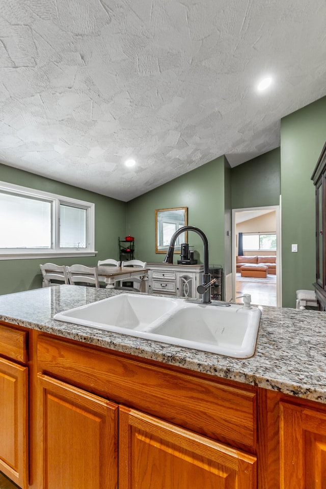 1027 Crestridge Dr, Rossville, GA 30741 - kitchen with brown cabinets, recessed lighting, and light stone countertops