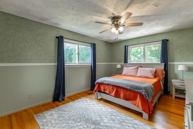 1027 Crestridge Dr, Rossville, GA 30741 - bedroom with multiple windows, wood finished floors, and a ceiling fan
