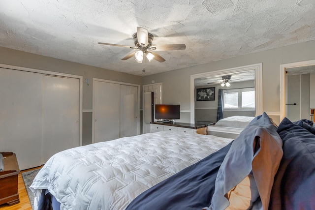 1027 Crestridge Dr, Rossville, GA 30741 - bedroom featuring multiple closets, wood finished floors, ceiling fan, and a textured ceiling