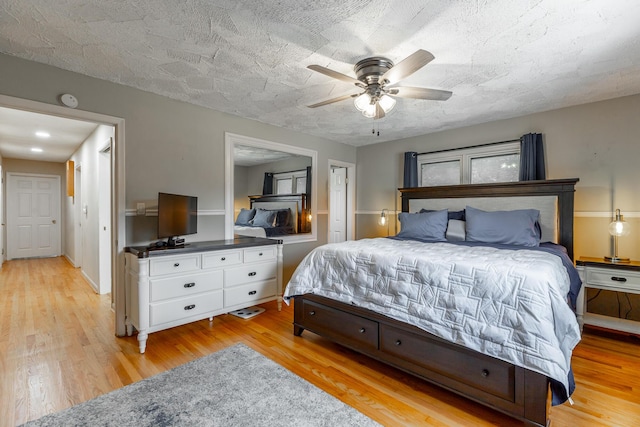 1027 Crestridge Dr, Rossville, GA 30741 - bedroom with light wood-style flooring, ceiling fan, and a textured ceiling