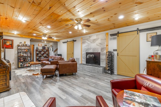 1027 Crestridge Dr, Rossville, GA 30741 - living area with a barn door, ceiling fan, wood finished floors, ornamental molding, and recessed lighting