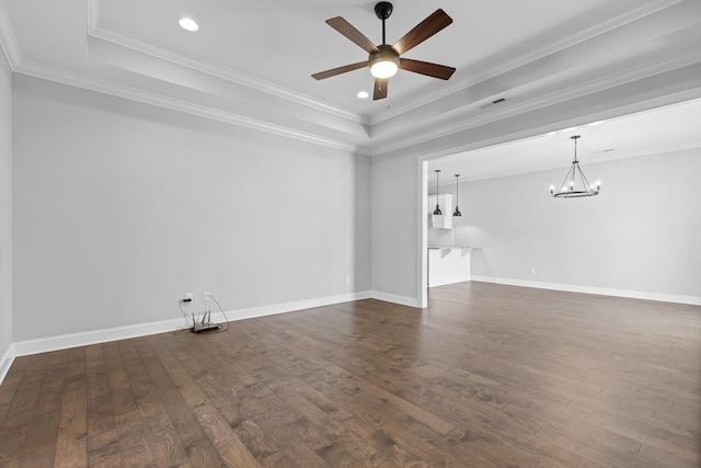 3480 Travertine Ln, Chattanooga, TN 37405 - unfurnished living room featuring a tray ceiling, dark wood-style floors, a ceiling fan, a chandelier, and ornamental molding