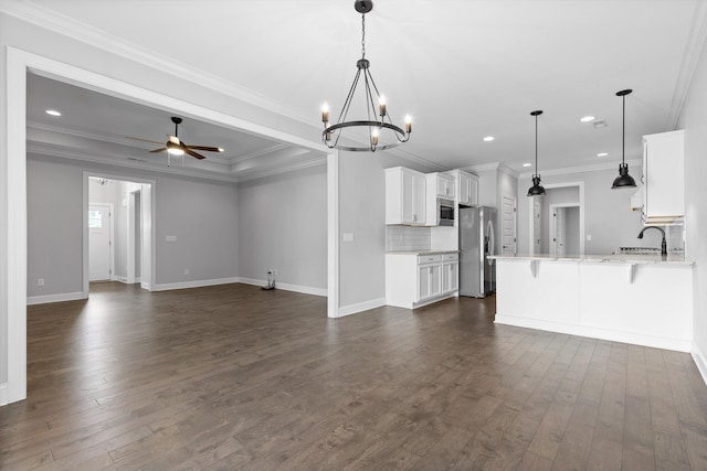 3480 Travertine Ln, Chattanooga, TN 37405 - unfurnished living room featuring dark wood-type flooring, a chandelier, recessed lighting, a ceiling fan, and ornamental molding