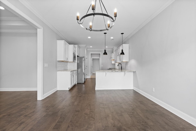 3480 Travertine Ln, Chattanooga, TN 37405 - kitchen featuring stainless steel appliances, a chandelier, white cabinets, tasteful backsplash, and a peninsula