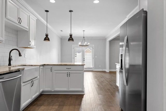 3480 Travertine Ln, Chattanooga, TN 37405 - kitchen with appliances with stainless steel finishes, a peninsula, decorative backsplash, white cabinetry, and dark wood-style floors