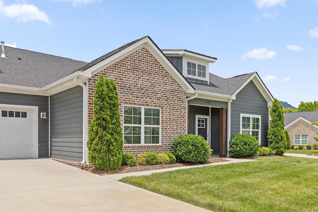 3480 Travertine Ln, Chattanooga, TN 37405 - traditional-style house with brick siding, a shingled roof, a front lawn, an attached garage, and driveway