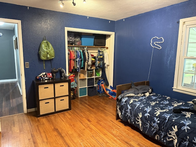 78 Mcdonough St, Dunlap, TN 37327 - bedroom with a textured wall, wood finished floors, a closet, and a textured ceiling
