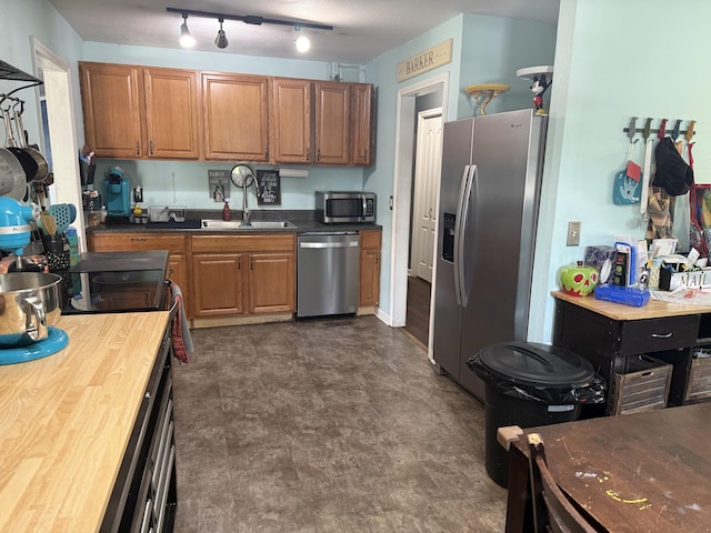 78 Mcdonough St, Dunlap, TN 37327 - kitchen with appliances with stainless steel finishes, brown cabinetry, dark floors, and wood counters