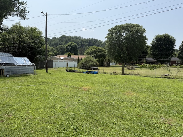 78 Mcdonough St, Dunlap, TN 37327 - view of yard featuring a greenhouse and an outbuilding