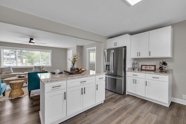 185 Block Rd, Rossville, GA 30741 - kitchen featuring stainless steel refrigerator with ice dispenser, open floor plan, wood finished floors, and white cabinetry
