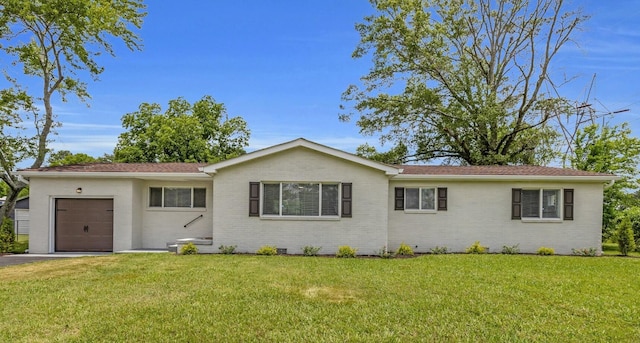 185 Block Rd, Rossville, GA 30741 - ranch-style house featuring an attached garage, brick siding, a front yard, and asphalt driveway