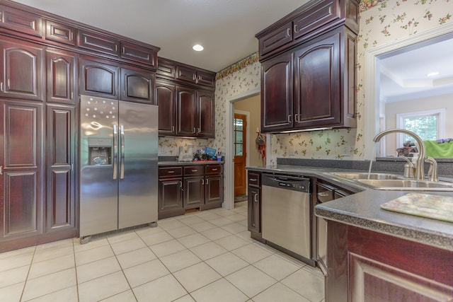1103 Monroe Green Rd, Trion, GA 30753 - kitchen with stainless steel appliances, wallpapered walls, dark countertops, reddish brown cabinets, and light tile patterned flooring