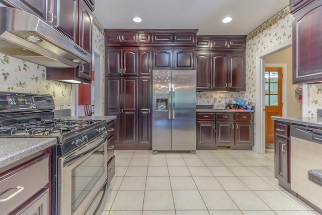 1103 Monroe Green Rd, Trion, GA 30753 - kitchen with appliances with stainless steel finishes, dark brown cabinets, under cabinet range hood, wallpapered walls, and light tile patterned flooring
