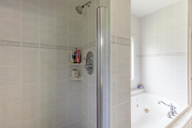 1103 Monroe Green Rd, Trion, GA 30753 - bathroom with a shower stall, a tub with jets, and tile walls