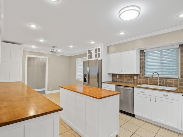 957 Elaine Trl, Chattanooga, TN 37421 - kitchen featuring stainless steel appliances, butcher block countertops, a kitchen island, ornamental molding, and light tile patterned floors