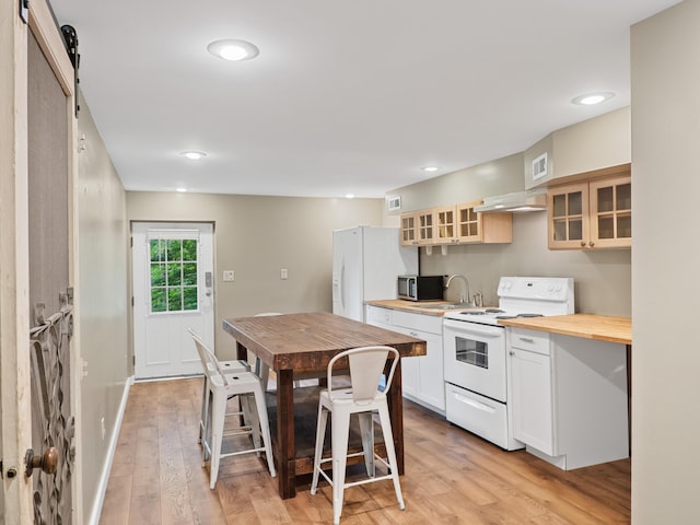 957 Elaine Trl, Chattanooga, TN 37421 - kitchen with white appliances, light wood-style flooring, wood counters, glass insert cabinets, and a barn door