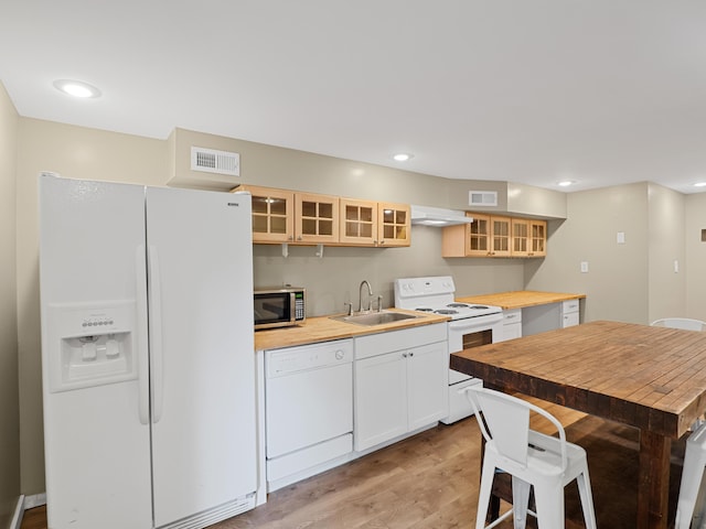 957 Elaine Trl, Chattanooga, TN 37421 - kitchen featuring white appliances, butcher block counters, glass insert cabinets, light wood-type flooring, and under cabinet range hood
