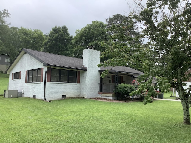 1322 Vance Rd, Chattanooga, TN 37421 - view of front of home featuring a chimney, brick siding, a front lawn, and covered porch