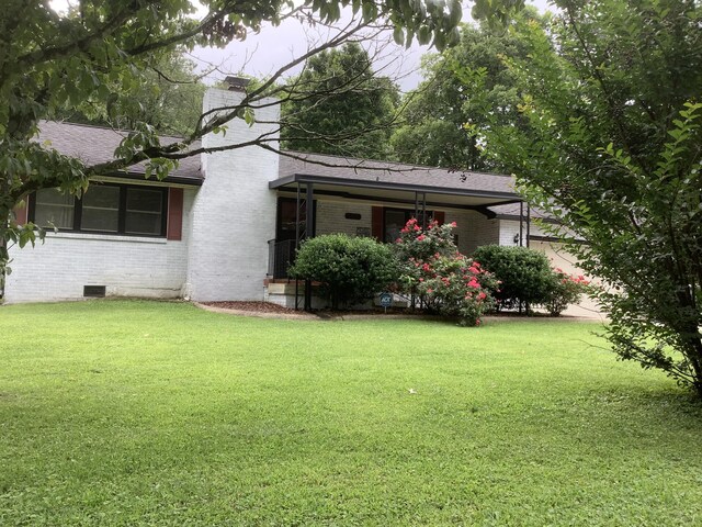 1322 Vance Rd, Chattanooga, TN 37421 - back of house featuring brick siding, a lawn, a chimney, and a shingled roof