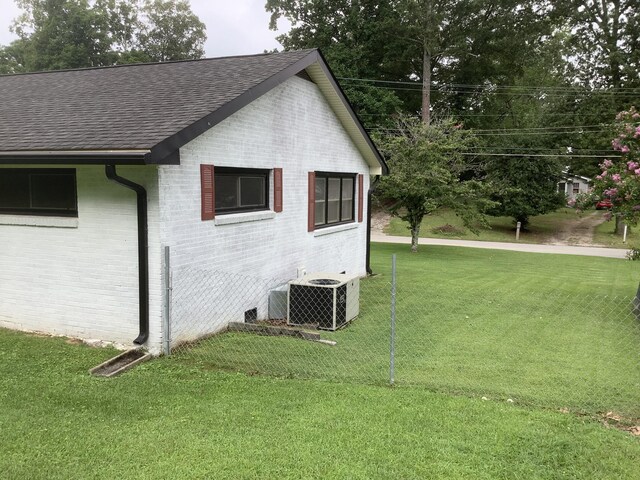 1322 Vance Rd, Chattanooga, TN 37421 - view of home's exterior with a shingled roof, a lawn, and brick siding