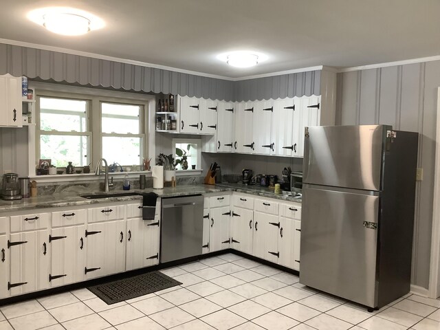 1322 Vance Rd, Chattanooga, TN 37421 - kitchen featuring stainless steel appliances, white cabinets, ornamental molding, dark stone countertops, and light tile patterned flooring
