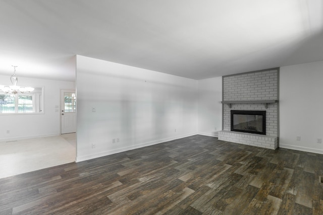 2046 N Concord Rd, Chattanooga, TN 37421 - unfurnished living room with wood finished floors, a chandelier, and a brick fireplace