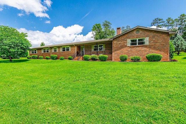 2046 N Concord Rd, Chattanooga, TN 37421 - ranch-style house featuring a front lawn, a chimney, brick siding, and covered porch