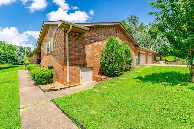 2046 N Concord Rd, Chattanooga, TN 37421 - view of side of home with brick siding, a yard, and an attached garage