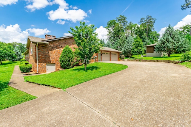 2046 N Concord Rd, Chattanooga, TN 37421 - view of front of property featuring brick siding, concrete driveway, a front lawn, and a chimney