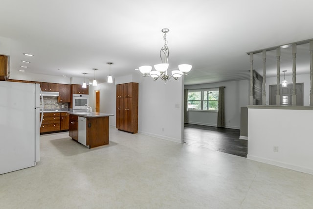 2046 N Concord Rd, Chattanooga, TN 37421 - kitchen featuring white appliances, backsplash, a chandelier, a kitchen island with sink, and open floor plan
