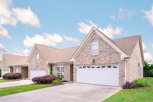 6239 Jacq Ct Unit 57, Hixson, TN 37343 - traditional-style home with driveway, a shingled roof, brick siding, and a front yard