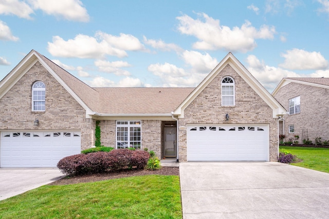 6239 Jacq Ct Unit 57, Hixson, TN 37343 - traditional-style house with concrete driveway, brick siding, and a front yard