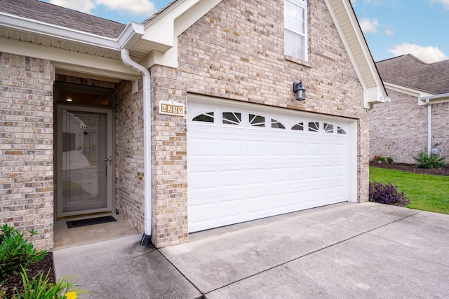 6239 Jacq Ct Unit 57, Hixson, TN 37343 - doorway to property featuring driveway, a garage, brick siding, and a shingled roof