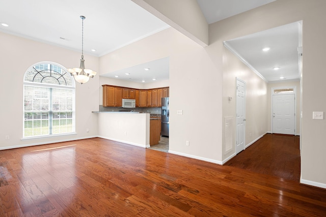 6239 Jacq Ct Unit 57, Hixson, TN 37343 - unfurnished living room with crown molding, a chandelier, wood finished floors, and recessed lighting
