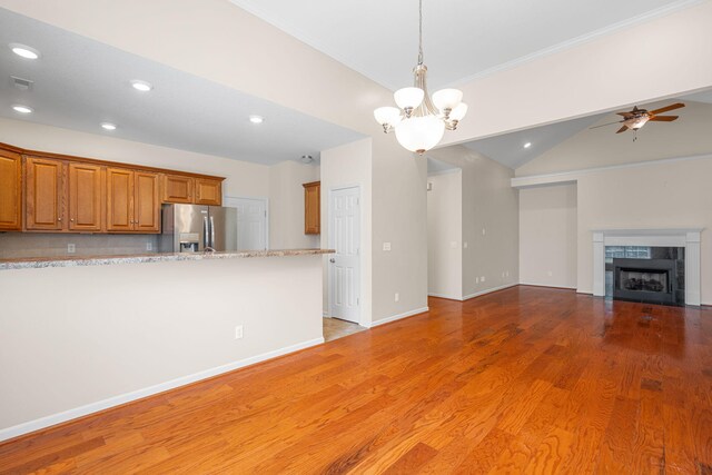 6239 Jacq Ct Unit 57, Hixson, TN 37343 - kitchen with stainless steel refrigerator with ice dispenser, brown cabinetry, open floor plan, crown molding, and recessed lighting