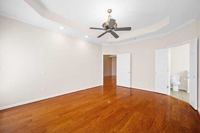 6239 Jacq Ct Unit 57, Hixson, TN 37343 - unfurnished bedroom with a tray ceiling, recessed lighting, crown molding, light wood-style flooring, and ensuite bathroom