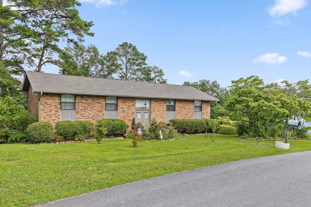 1008 Panorama Dr, Chattanooga, TN 37421 - view of front of home with brick siding, a front yard, and roof with shingles