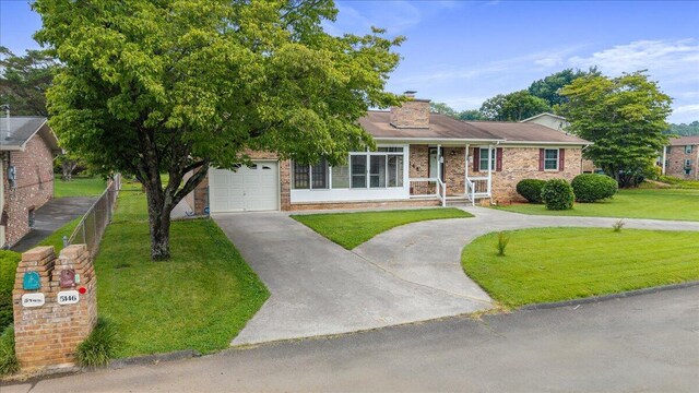 5146 Creek Bend Cir NW, Cleveland, TN 37312 - single story home featuring concrete driveway, a front yard, a garage, a chimney, and brick siding