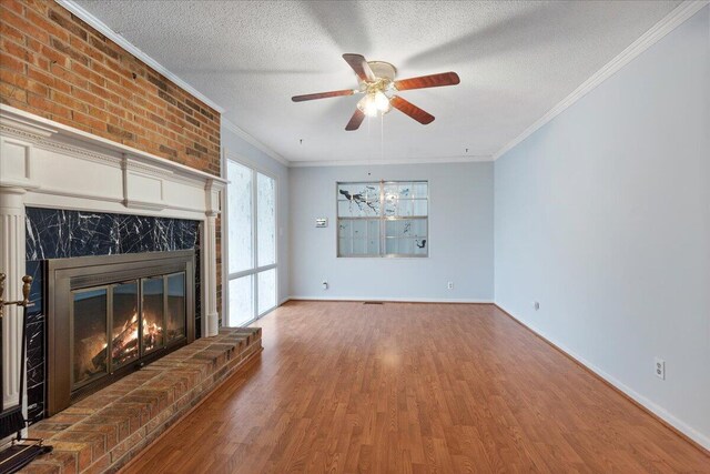 5146 Creek Bend Cir NW, Cleveland, TN 37312 - unfurnished living room featuring a large fireplace, wood finished floors, ceiling fan, ornamental molding, and a textured ceiling